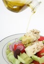 Pouring oil on Greek salad vertical Royalty Free Stock Photo