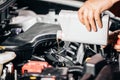 Pouring oil to car engine, closeup