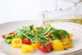 Pouring of olive oil onto tasty vegetable salad, closeup Royalty Free Stock Photo