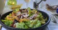 Pouring olive oil over a Caesar`s salad Royalty Free Stock Photo