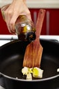 Pouring olive oil over melting butter