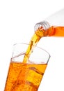 Pouring orange energy drink from bottle to glass Royalty Free Stock Photo