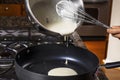 Pouring Pancake Batter into frying pan Royalty Free Stock Photo