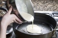 Pouring Pancake mix into hot frying pan Royalty Free Stock Photo