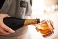 Pouring the perfect drink. Cropped view of a womans hands pouring a drink. Royalty Free Stock Photo