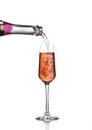 Pouring pink rose champagne from bottle to glass Royalty Free Stock Photo