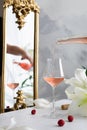 Pouring pink rose wine into a glass. Celebration, wedding party, happy birthday, St. Valentin`s Day concept. Pink wine tasting. Royalty Free Stock Photo