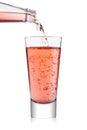 Pouring pink soda lemonade from bottle to glass Royalty Free Stock Photo