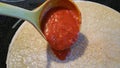 Pouring Pizza Sauce