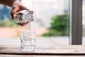 Pouring purified fresh drink water from the bottle on table in l