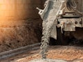 Pouring ready-mixed concrete after placing steel reinforcement to make the road by mixing in construction site Royalty Free Stock Photo