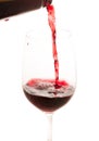 Pouring red wine from bottle in the glass Royalty Free Stock Photo