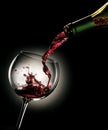 Pouring red wine from a bottle into a glass Royalty Free Stock Photo