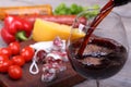 Pouring red wine and food bachground Royalty Free Stock Photo