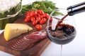 Pouring red wine and food bachground Royalty Free Stock Photo