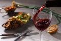 Pouring red wine and food Royalty Free Stock Photo