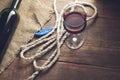 Pouring red wine glass against wooden background Royalty Free Stock Photo