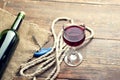 Pouring red wine glass against wooden background Royalty Free Stock Photo