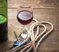 Pouring red wine glass against wooden background Royalty Free Stock Photo