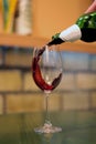 Pouring red wine in glass at bar Royalty Free Stock Photo