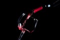 Pouring red wine glass black background Royalty Free Stock Photo