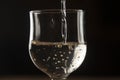 pouring red wine into a glass from a clay bottle on a black background Royalty Free Stock Photo