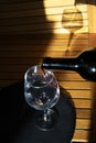 Pouring red wine into a glass of wine Royalty Free Stock Photo