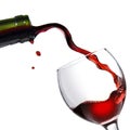 Pouring red wine in glass goblet isolated on white Royalty Free Stock Photo