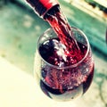 pouring red wine. Wine in a glass, selective focus, motion blur, Royalty Free Stock Photo