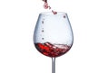Pouring red wine into a glass with splashes on a white background Royalty Free Stock Photo