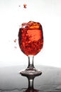 Pouring red wine into a glass of water Royalty Free Stock Photo