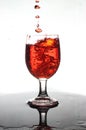 Pouring red wine into a glass of water Royalty Free Stock Photo