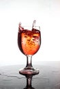 Pouring red wine into a glass of water Royalty Free Stock Photo