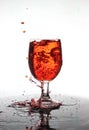 Pouring red wine into a glass of water Royalty Free Stock Photo