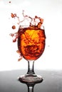 Pouring red wine into a glass of water Royalty Free Stock Photo