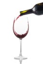 Pouring red wine into glass on white background Royalty Free Stock Photo