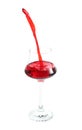 Pouring red wine in glass on white background Royalty Free Stock Photo
