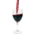 Pouring Red wine into a Glass on a white background. Royalty Free Stock Photo