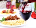 Pouring red wine and pasta Royalty Free Stock Photo