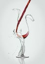 Pouring red wine to glass with water splashes Royalty Free Stock Photo