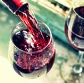 pouring red wine. Wine in a glass, selective focus, motion blur, Royalty Free Stock Photo