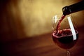 Pouring red wine into a wineglass Royalty Free Stock Photo