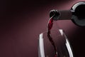 Pouring red wine into a wineglass Royalty Free Stock Photo