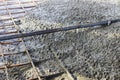 Pouring the reinforced floor with concrete along metal guides. Close-up Royalty Free Stock Photo