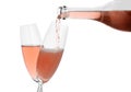 Pouring rose champagne from bottle into glass Royalty Free Stock Photo