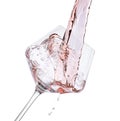 Pouring rose wine into glass isolated on white Royalty Free Stock Photo