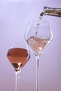 Pouring rose wine into wine glasses