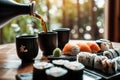 pouring sake into a cup beside a sushi set Royalty Free Stock Photo