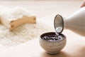 Pouring sake into a small Japanese cup Royalty Free Stock Photo