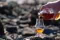 Pouring of Scotch whisky in tasting glass